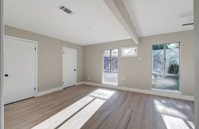 a view of wooden floor and windows in a room