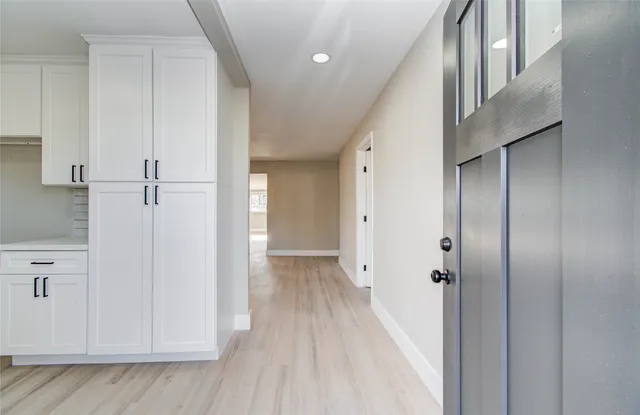 a view of a hallway with wooden floor