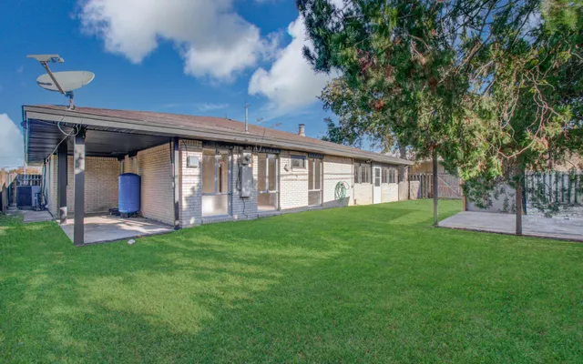 a view of a house with a yard and porch