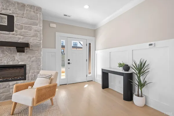 a living room with furniture wooden floor and a chandelier