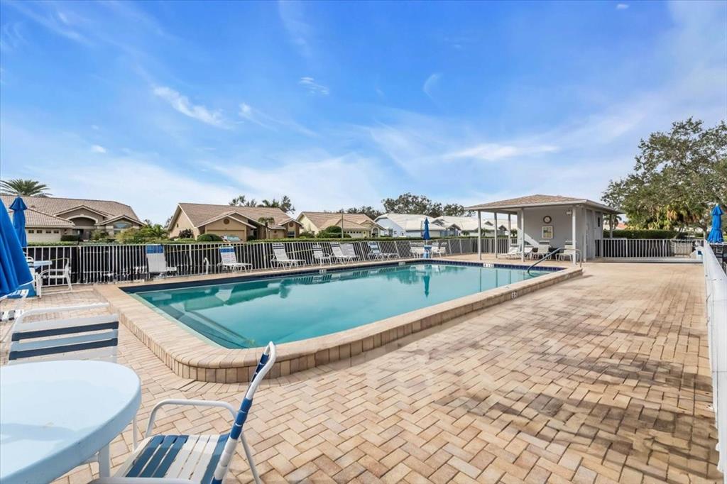 6713 Stone River Road, Unit 206 Bradenton, FL 34203 - Photo 5 of 58 a view of a swimming pool with a lounge chair