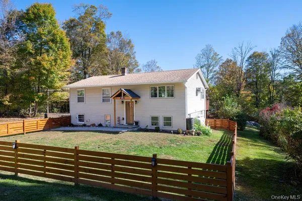 a view of a house with backyard and sitting area