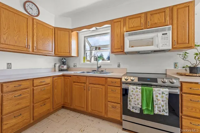 a kitchen with stainless steel appliances granite countertop a sink stove and cabinets