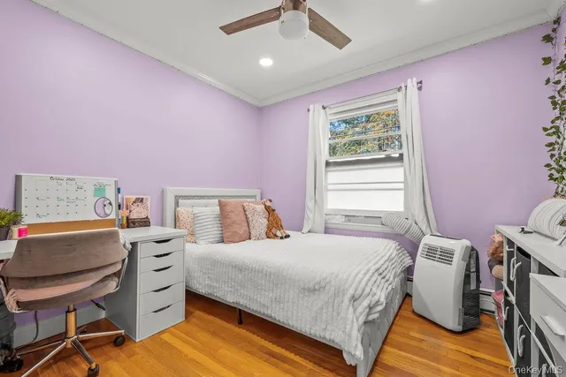 a bedroom with a bed a desk and chair