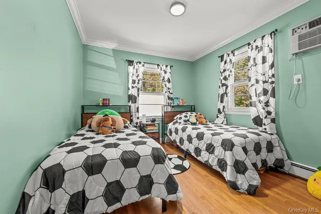 a bedroom with two beds and a window