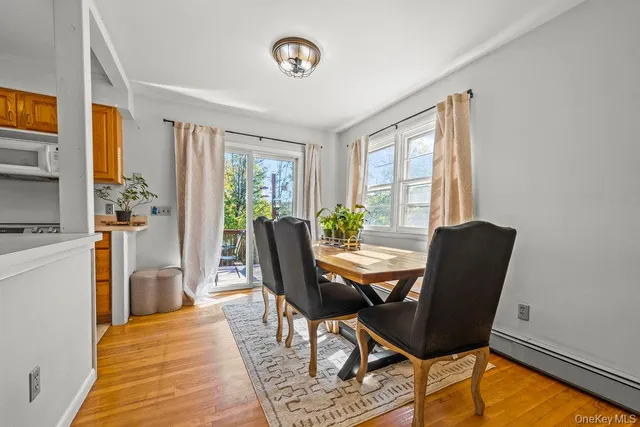 a view of a dining room with furniture and a window