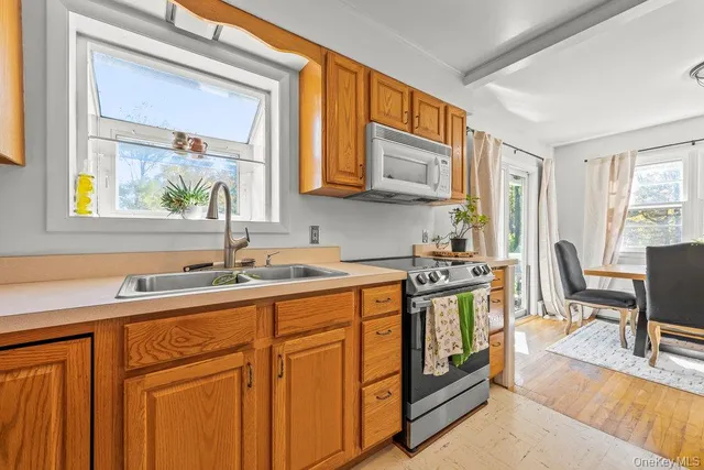 a kitchen with stainless steel appliances granite countertop a sink stove and cabinets