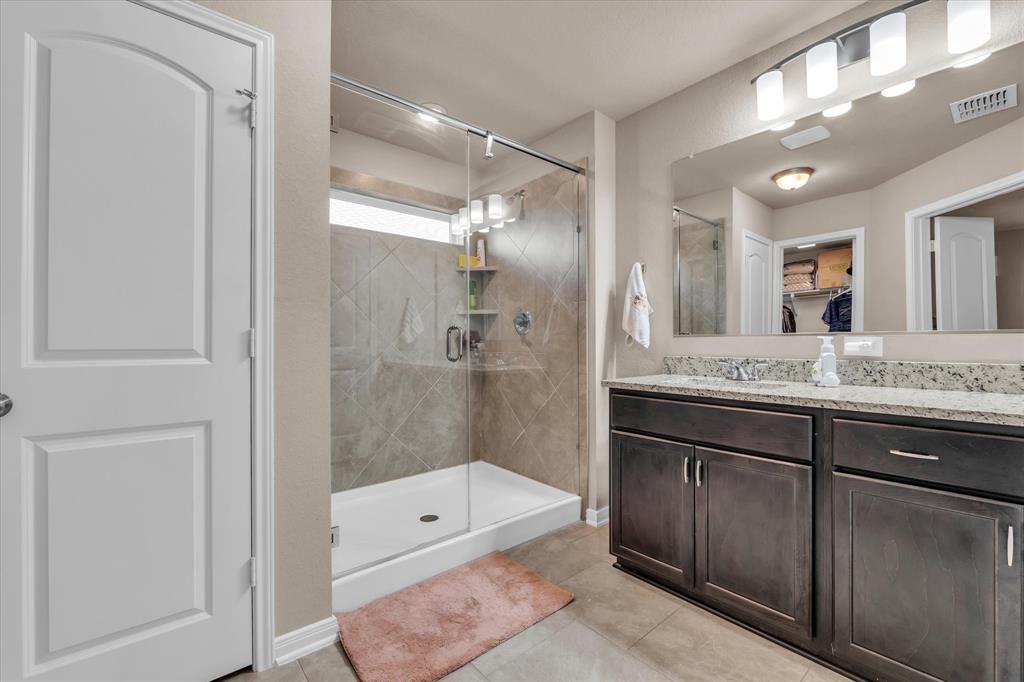 917 North Fork Ranch Road Waco, TX 76705 - Photo 12 of 23 a bathroom with a granite countertop sink mirror and shower
