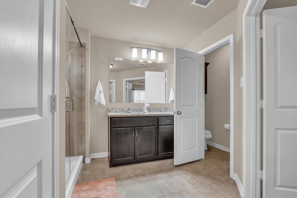 917 North Fork Ranch Road Waco, TX 76705 - Photo 13 of 23 a spacious bathroom with a mirror and a shower