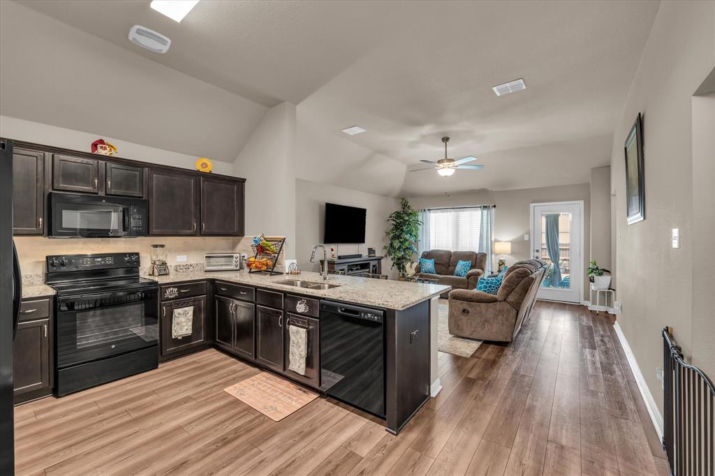 917 North Fork Ranch Road Waco, TX 76705 - Photo 6 of 23 a large kitchen with stainless steel appliances granite countertop a lot of counter space and wooden floor