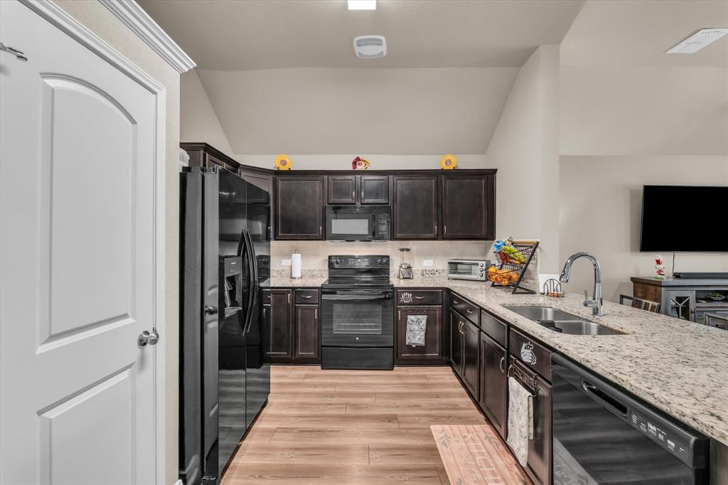 917 North Fork Ranch Road Waco, TX 76705 - Photo 7 of 23 a kitchen with stainless steel appliances granite countertop a refrigerator and a stove top oven