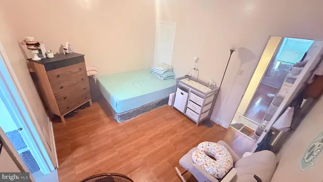 a bed room with furniture and a wooden floor