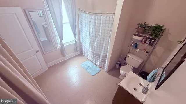 a view of roof deck with table and chairs under an umbrella