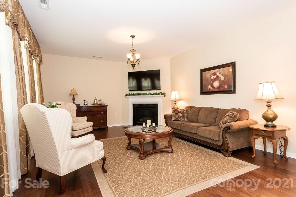 305 Allspice Road Fort Mill, SC 29708 - Photo 11 of 31 a living room with furniture a fireplace and a flat screen tv