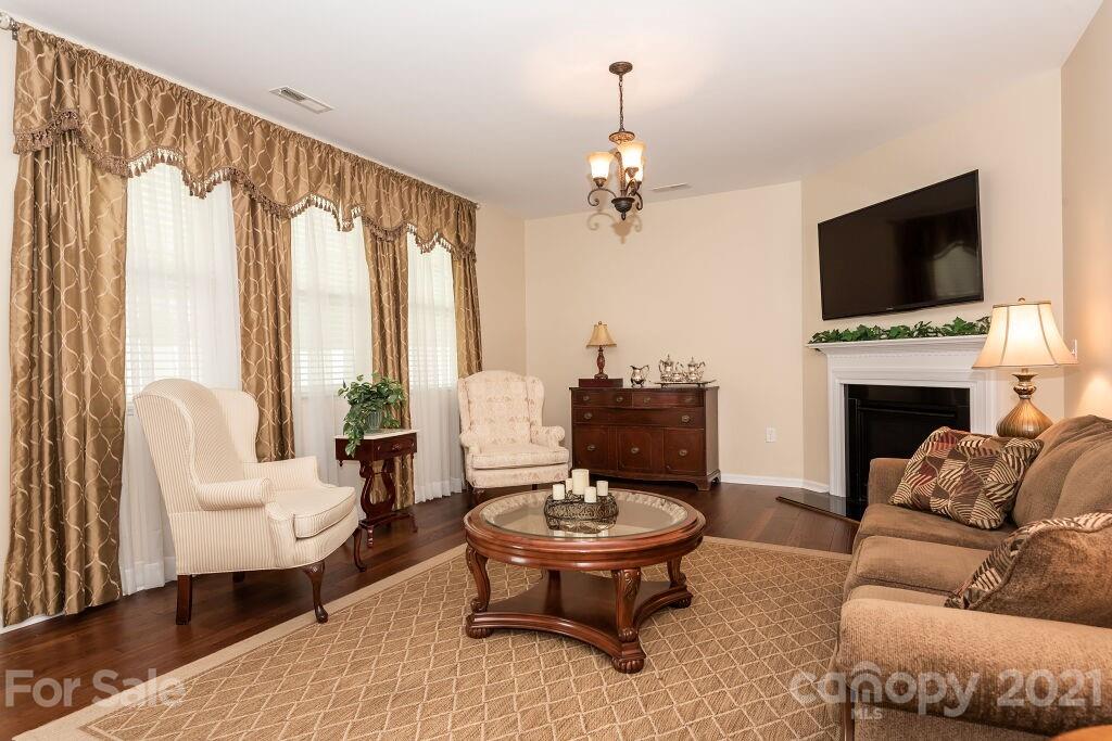 305 Allspice Road Fort Mill, SC 29708 - Photo 12 of 31 a living room with furniture a fireplace and a flat screen tv