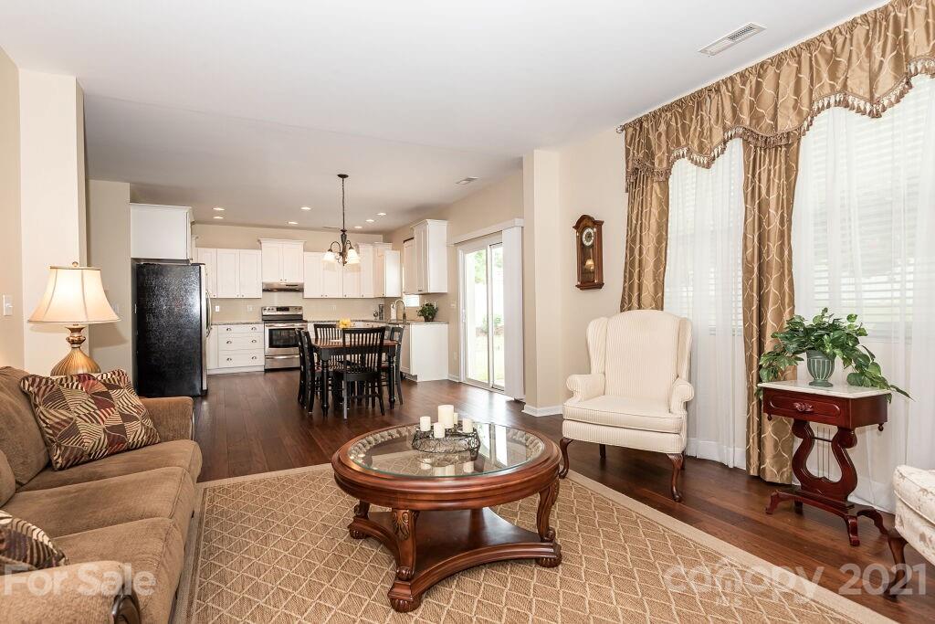 305 Allspice Road Fort Mill, SC 29708 - Photo 13 of 31 a living room with furniture and a dining table with kitchen view