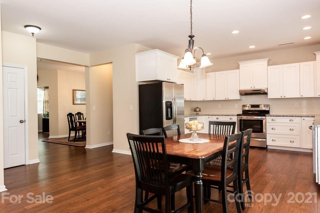 305 Allspice Road Fort Mill, SC 29708 - Photo 15 of 31 a dining room with stainless steel appliances kitchen island granite countertop a dining table chairs and a refrigerator