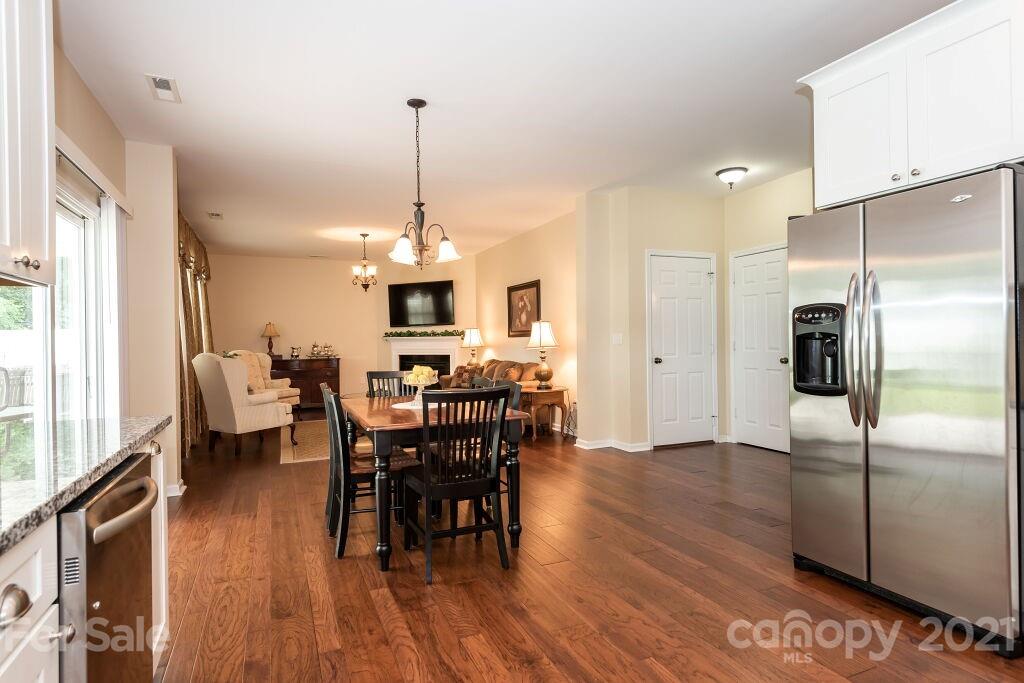 305 Allspice Road Fort Mill, SC 29708 - Photo 19 of 31 a view of a dining room and livingroom with furniture wooden floor a chandelier