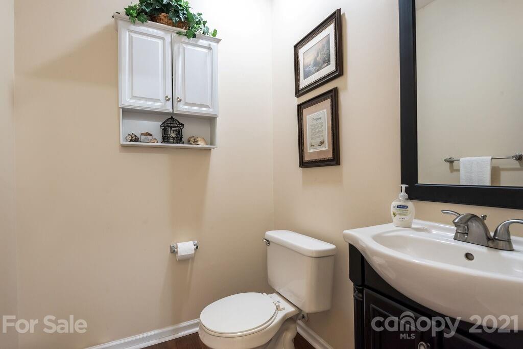 305 Allspice Road Fort Mill, SC 29708 - Photo 21 of 31 a bathroom with a sink a toilet and mirror