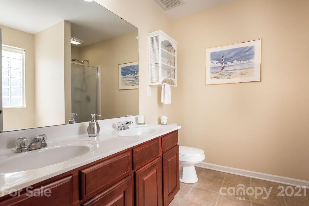 305 Allspice Road Fort Mill, SC 29708 - Photo 26 of 31 a bathroom with a granite countertop sink a toilet and a mirror