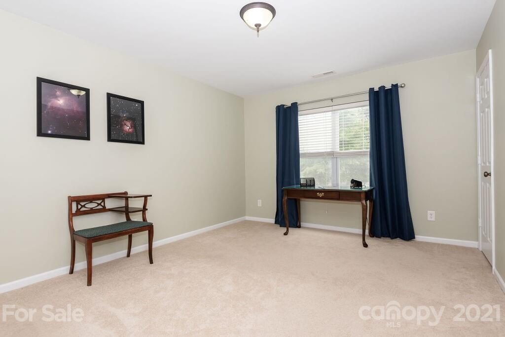 305 Allspice Road Fort Mill, SC 29708 - Photo 29 of 31 a bedroom with a bed and a chair
