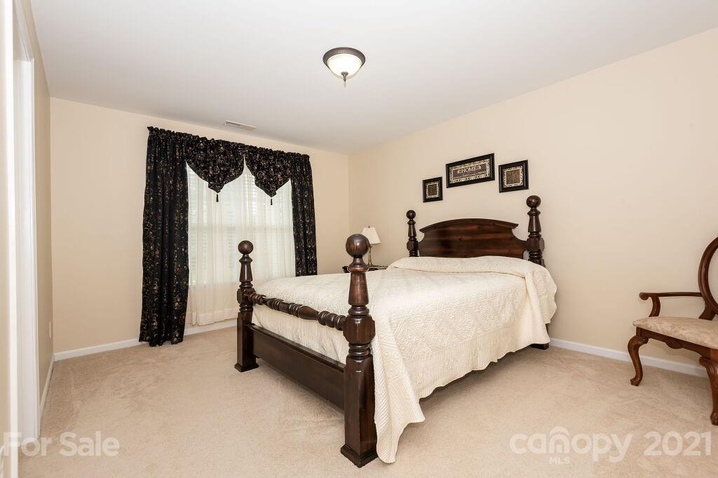 305 Allspice Road Fort Mill, SC 29708 - Photo 30 of 31 a bedroom with a bed and lamp