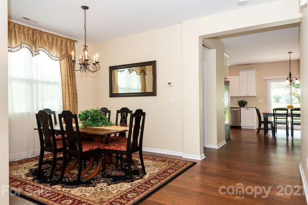 305 Allspice Road Fort Mill, SC 29708 - Photo 8 of 31 a view of a dining room with furniture window and wooden floor