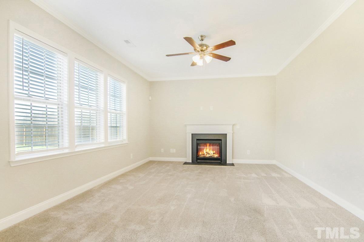 35 Waterpine Drive Garner, NC 27529 - Photo 15 of 25 a view of an empty room with a window and a fireplace