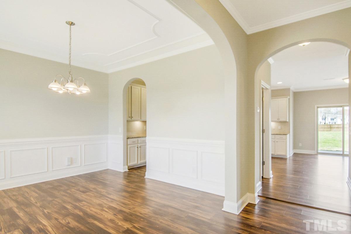 35 Waterpine Drive Garner, NC 27529 - Photo 16 of 25 a view of empty room with wooden floor and kitchen view