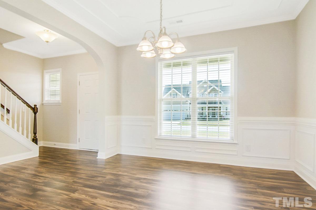 35 Waterpine Drive Garner, NC 27529 - Photo 17 of 25 a view of an empty room with wooden floor and a window