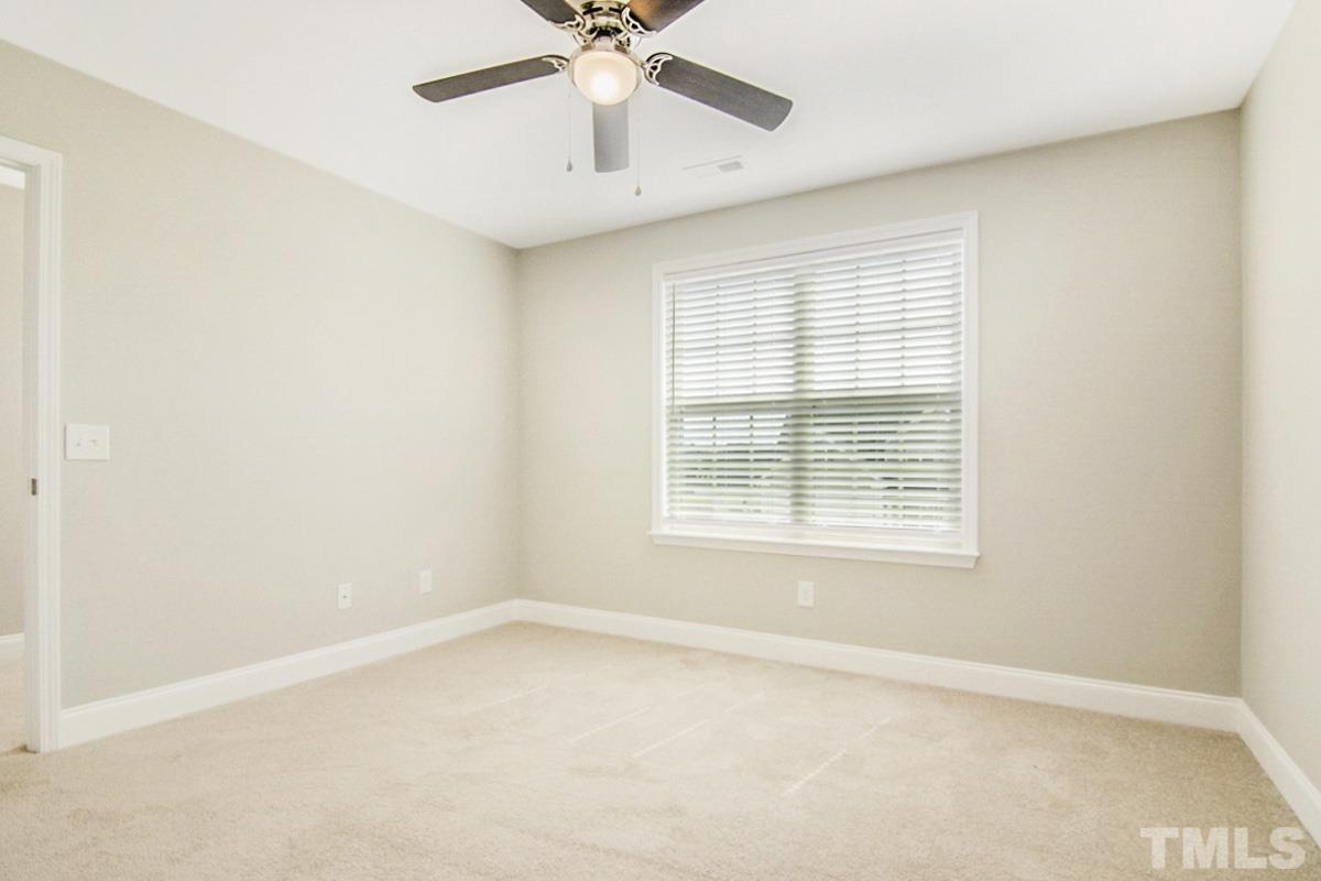 35 Waterpine Drive Garner, NC 27529 - Photo 24 of 25 an empty room with a window and a fan