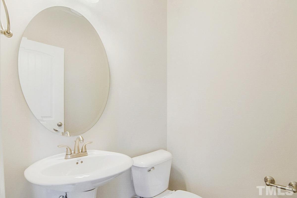 35 Waterpine Drive Garner, NC 27529 - Photo 9 of 25 a bathroom with a toilet a sink and mirror