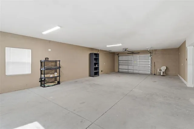 a view of an empty room with closet and lots of cabinet