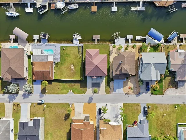 an aerial view of a house with outdoor space and a lake view