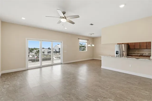 a view of a livingroom with furniture wooden floor and a ceiling fan