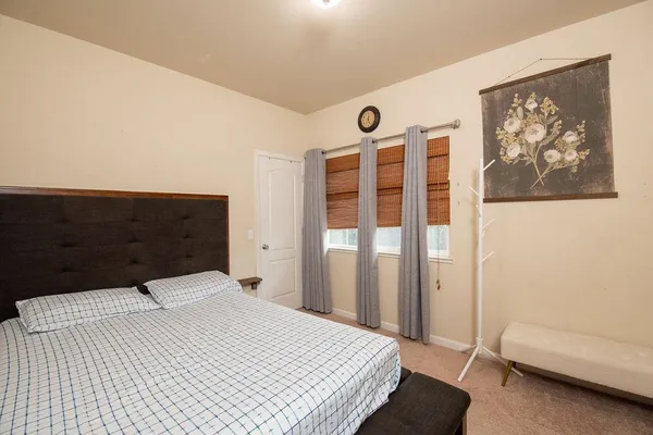 a bedroom with a bed and a couch