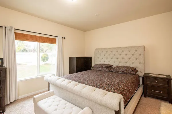 a bedroom with a bed and window