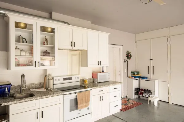 a kitchen with stainless steel appliances granite countertop a sink and cabinets