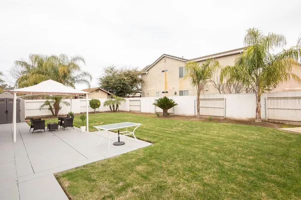 a swimming pool with outdoor seating and yard