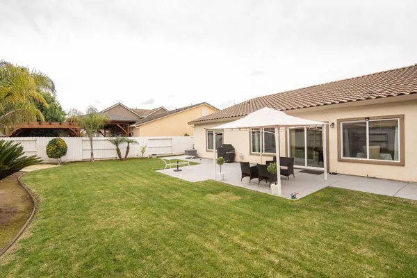 a front view of house with outdoor seating and yard