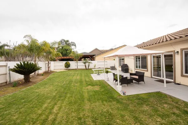 a view of a house with swimming pool and sitting area