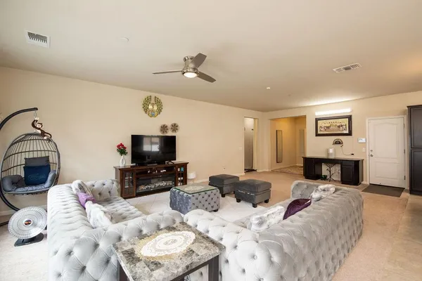 a living room with furniture flat screen tv and a fireplace