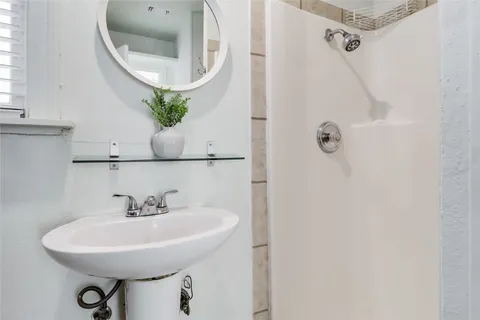 a bathroom with a sink a mirror and vanity
