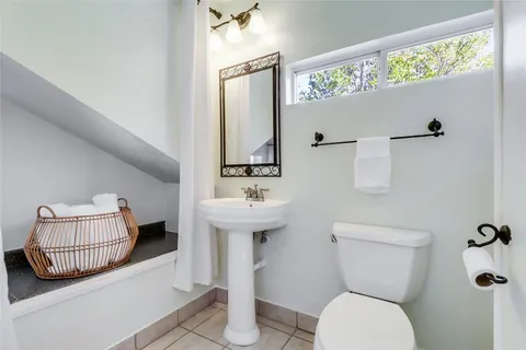 a bathroom with a sink mirror and toilet