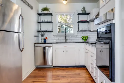 a kitchen with stainless steel appliances a sink and a refrigerator