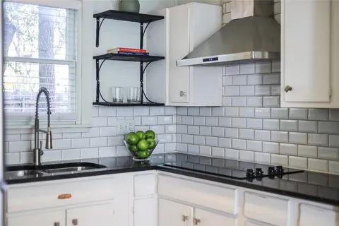 a view of a kitchen with a sink and cabinets