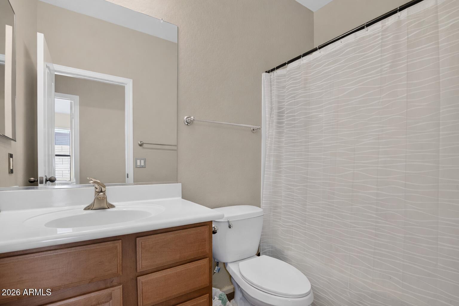 515 West Love Road San Tan Valley, AZ 85143 - Photo 23 of 74 a bathroom with a sink a toilet and shower
