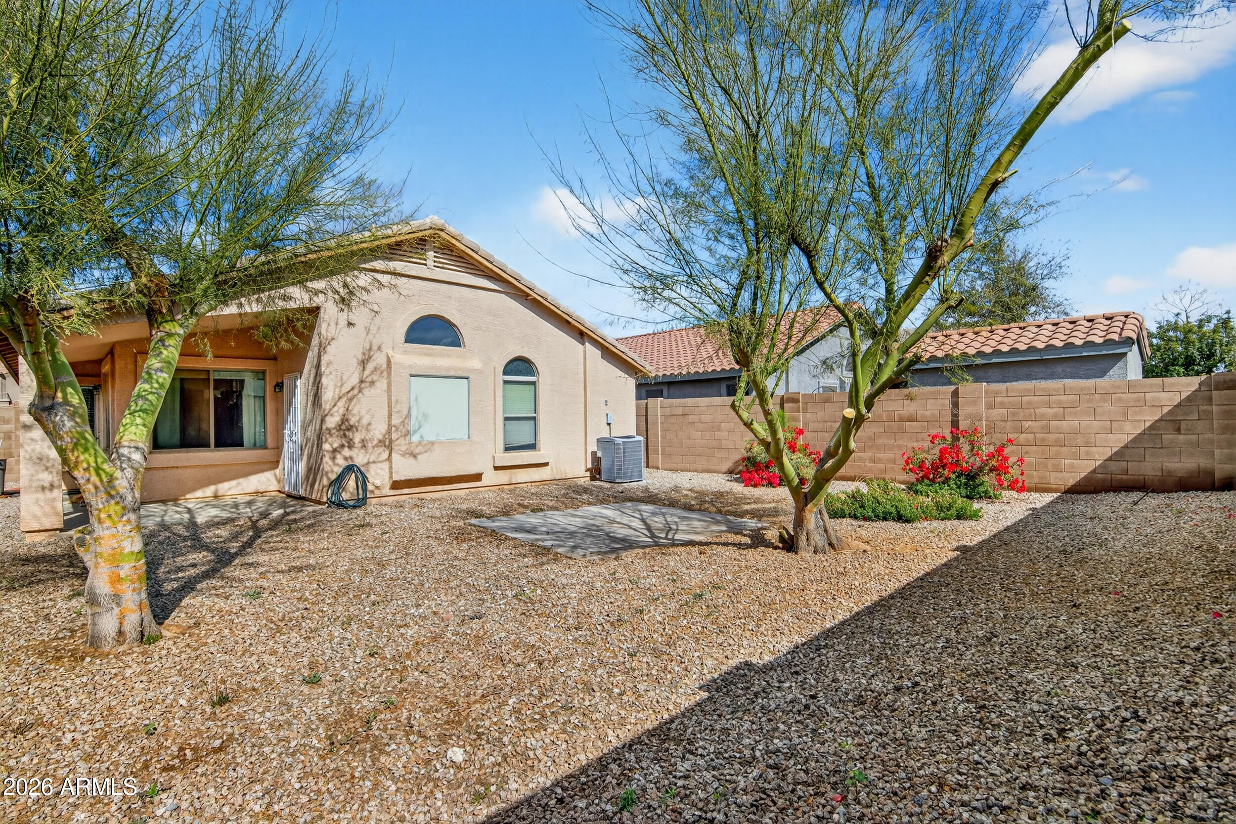 515 West Love Road San Tan Valley, AZ 85143 - Photo 27 of 74 a view of a white house with a yard and large tree