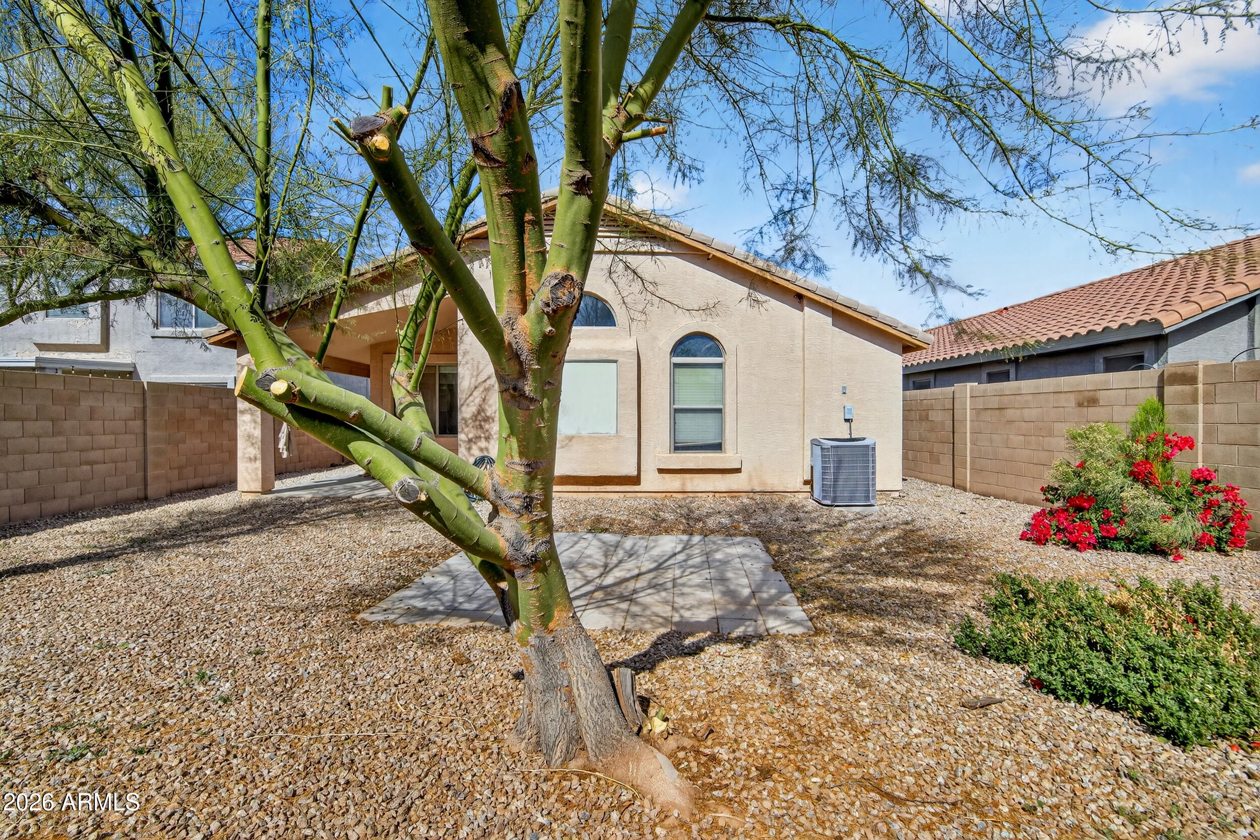 515 West Love Road San Tan Valley, AZ 85143 - Photo 28 of 74 a view of a house with a small yard and a large tree