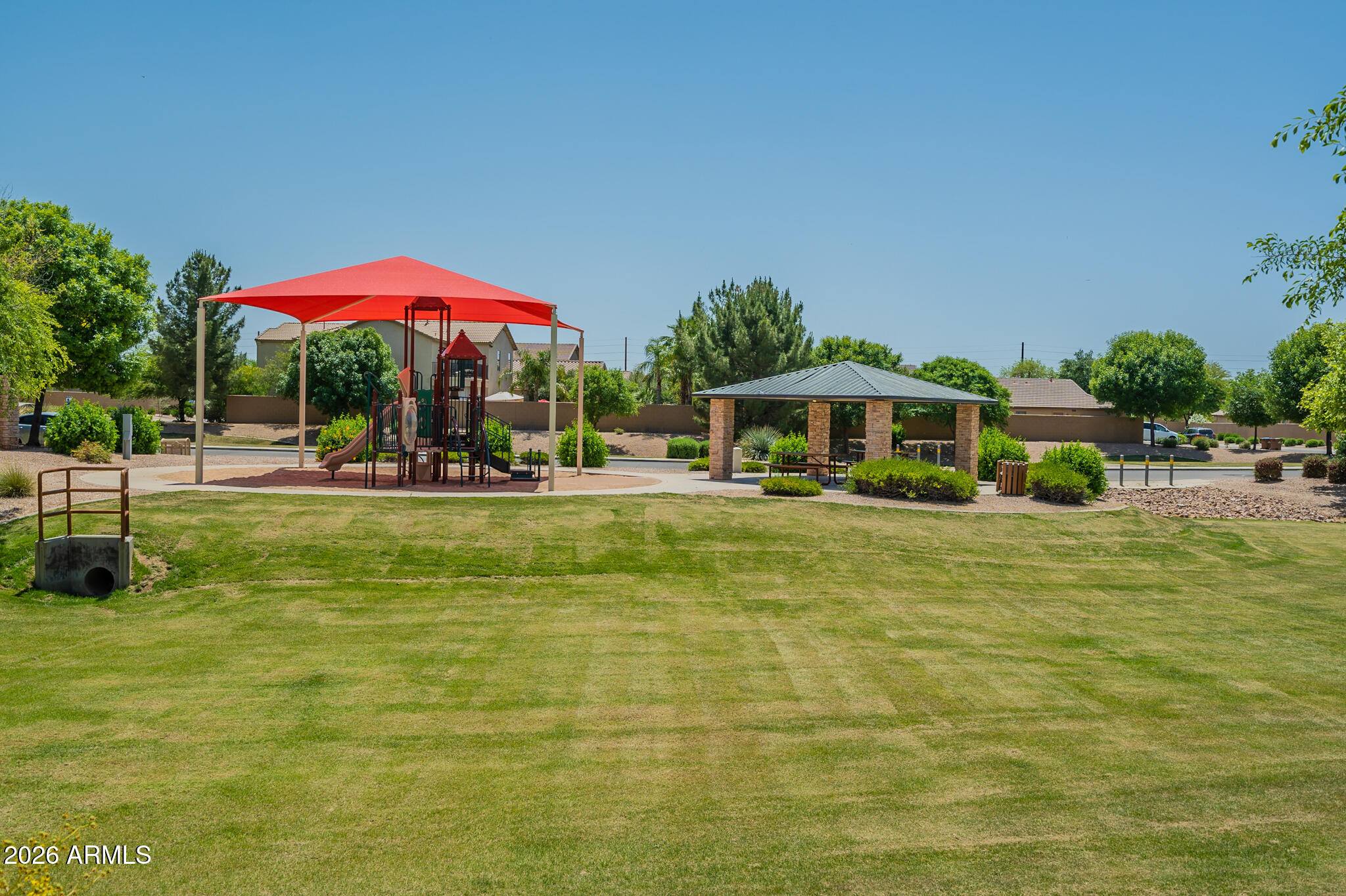 515 West Love Road San Tan Valley, AZ 85143 - Photo 59 of 74 a view of swimming pool with lawn chairs under an umbrella